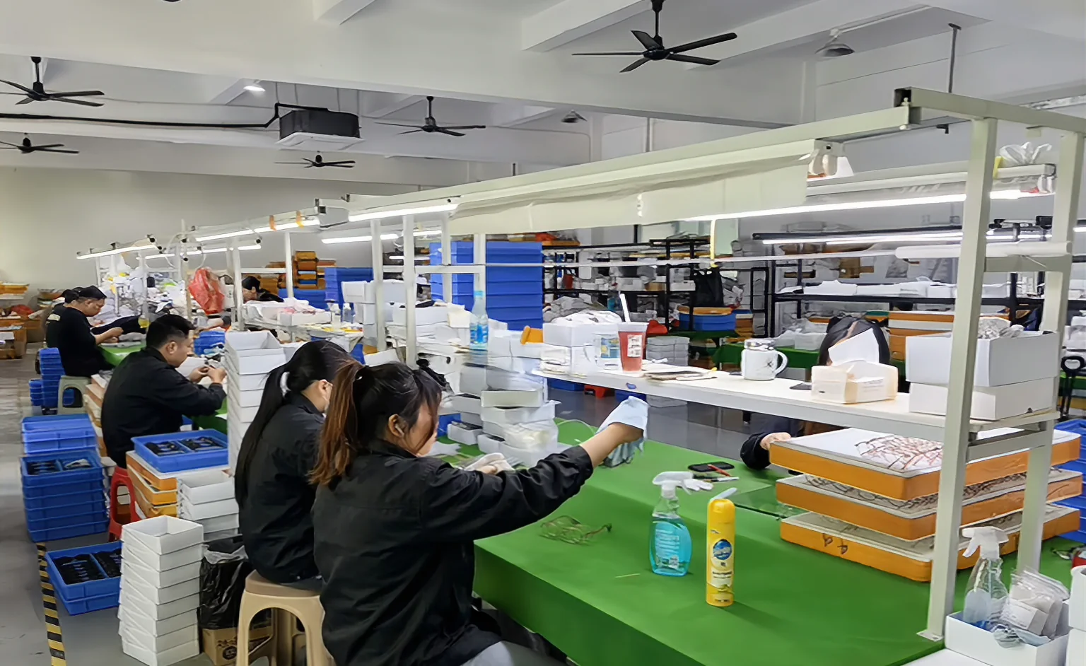 Eyewear workshop with operators working across production benches